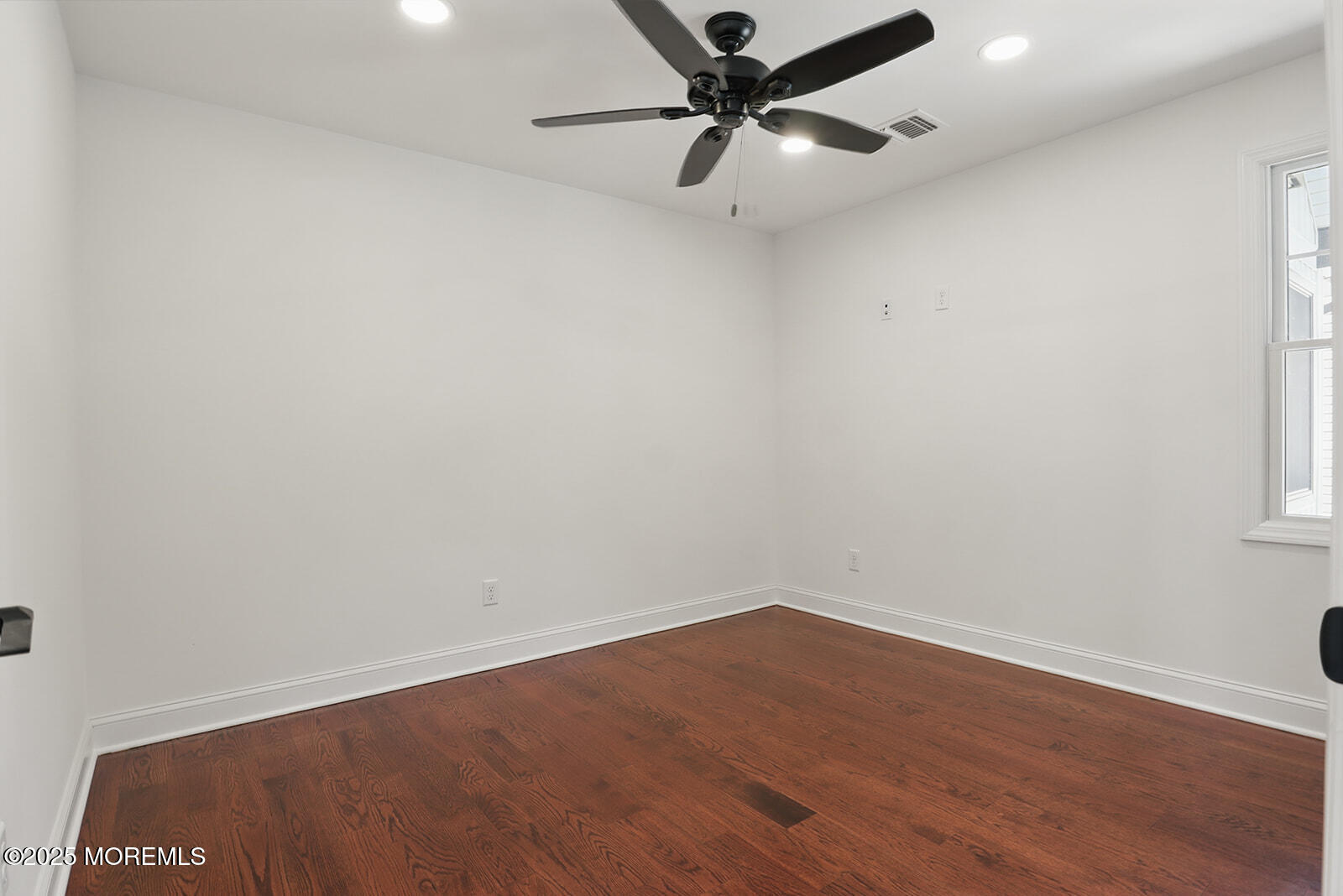 18 Neptune Place North Middletown, NJ 07748 - Photo 20 of 49 an empty room with a window and a fan