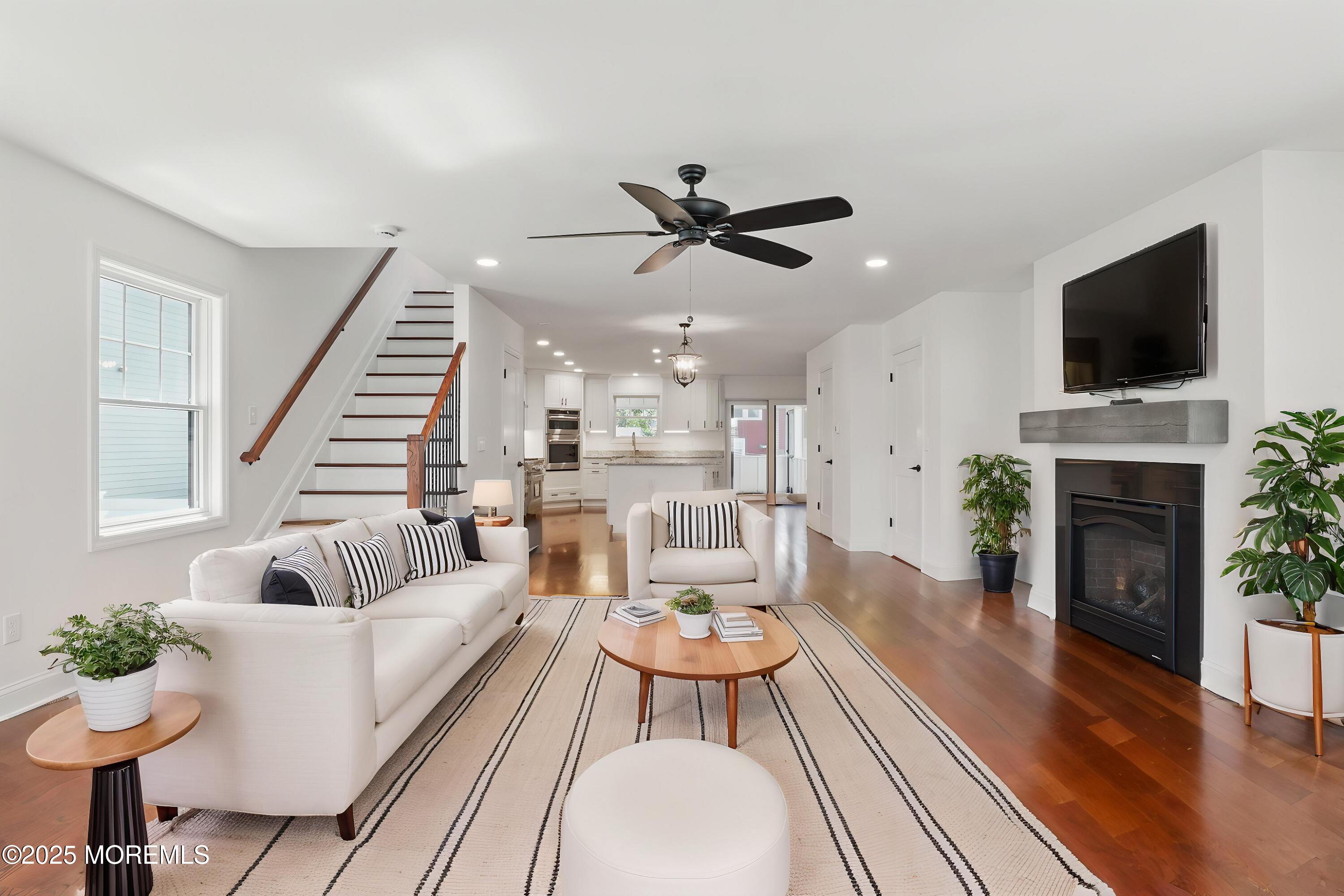 18 Neptune Place North Middletown, NJ 07748 - Photo 4 of 49 a living room with furniture fireplace and a flat screen tv