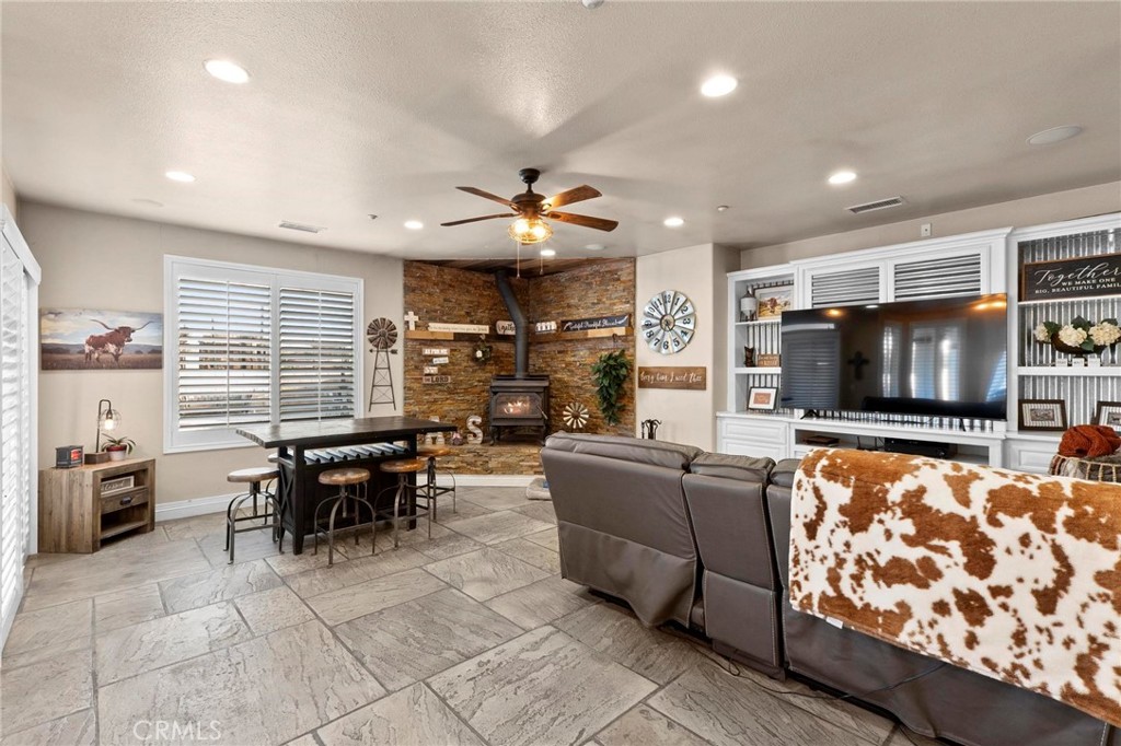 7381 Cygnet Road Phelan, CA 92371 - Photo 13 of 64 a living room with furniture a flat screen tv and kitchen view