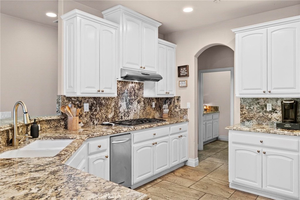 7381 Cygnet Road Phelan, CA 92371 - Photo 20 of 64 a kitchen with granite countertop a sink stainless steel appliances and cabinets