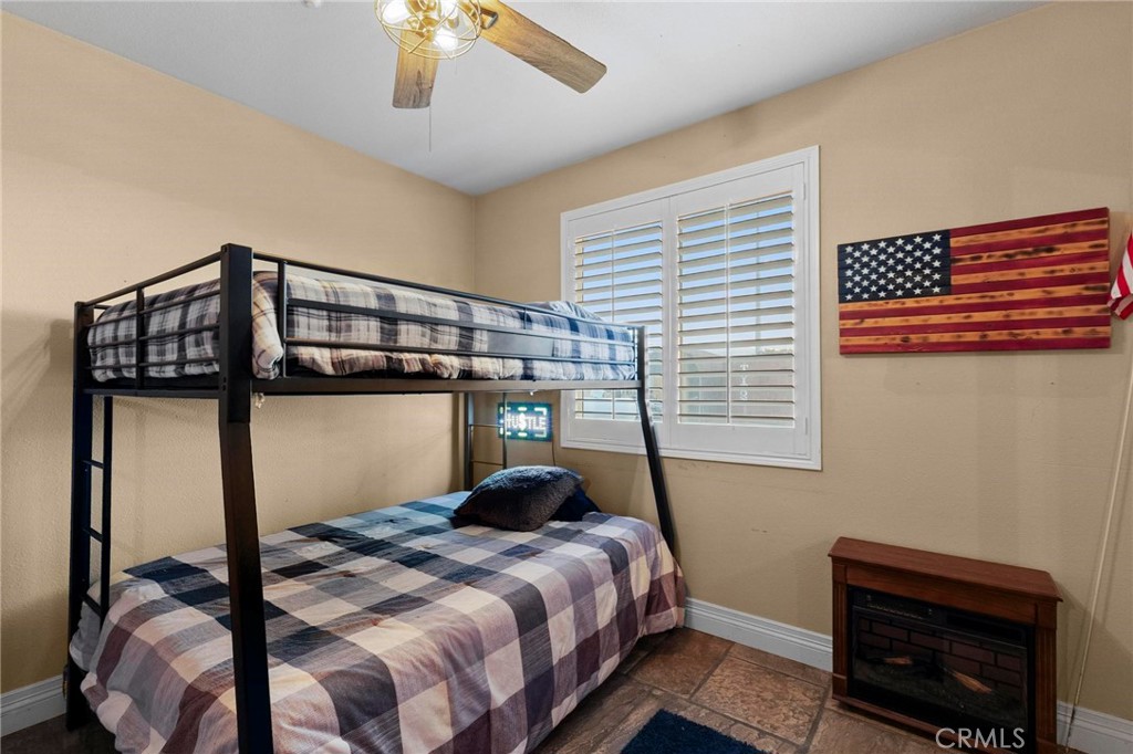 7381 Cygnet Road Phelan, CA 92371 - Photo 35 of 64 a bedroom with a bed window and a chandelier