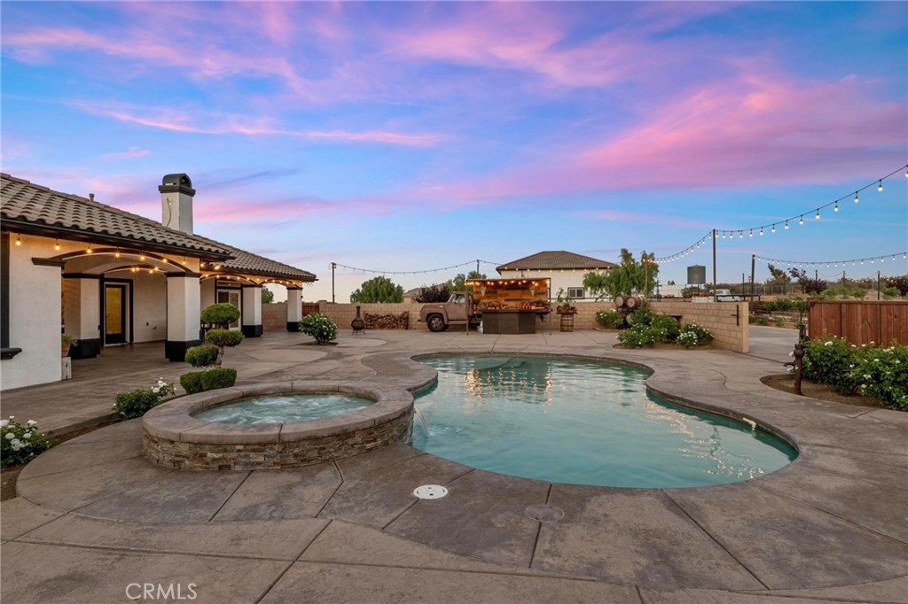 7381 Cygnet Road Phelan, CA 92371 - Photo 43 of 64 a view of a swimming pool with a table under an umbrella