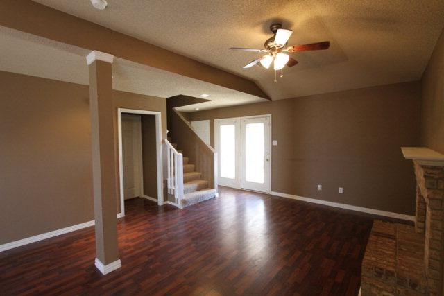 2723 110th Street Lubbock, TX 79423 - Photo 2 of 10 a view of an empty room with wooden floor and a ceiling fan