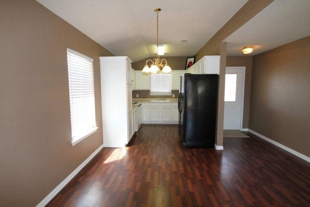 2723 110th Street Lubbock, TX 79423 - Photo 4 of 10 a kitchen with a refrigerator and wooden floor