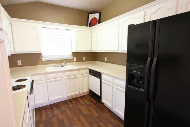 2723 110th Street Lubbock, TX 79423 - Photo 5 of 10 a kitchen with a refrigerator sink and cabinets
