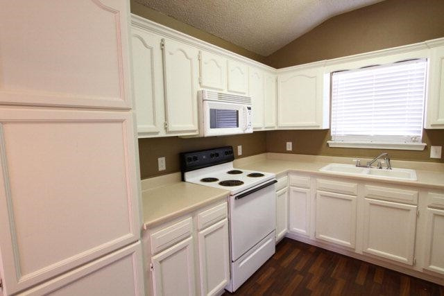 2723 110th Street Lubbock, TX 79423 - Photo 6 of 10 a kitchen with a sink stove and cabinets