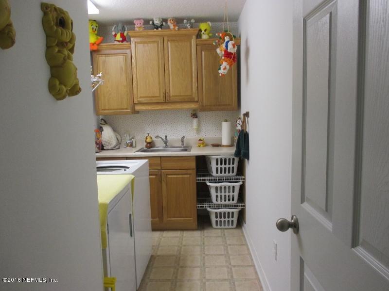 3036 Longleaf Ranch Circle Middleburg, FL 32068 - Photo 7 of 33 Laundry with sink and cabinlets