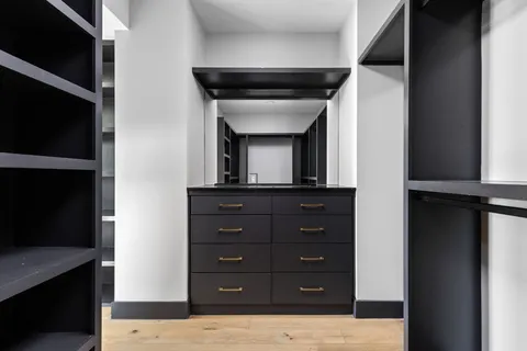 a living room with a dresser and a mirror