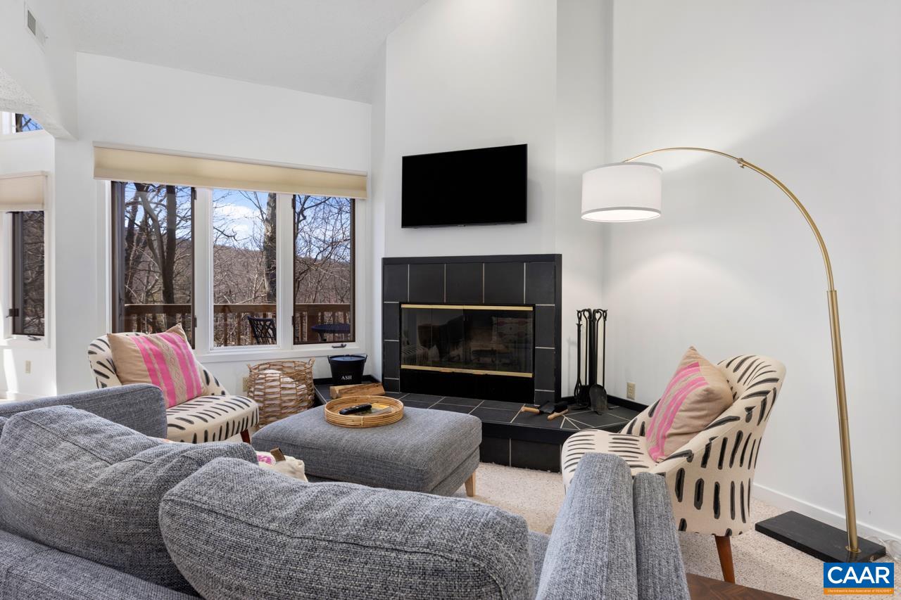 a living room with furniture fireplace and a flat screen tv