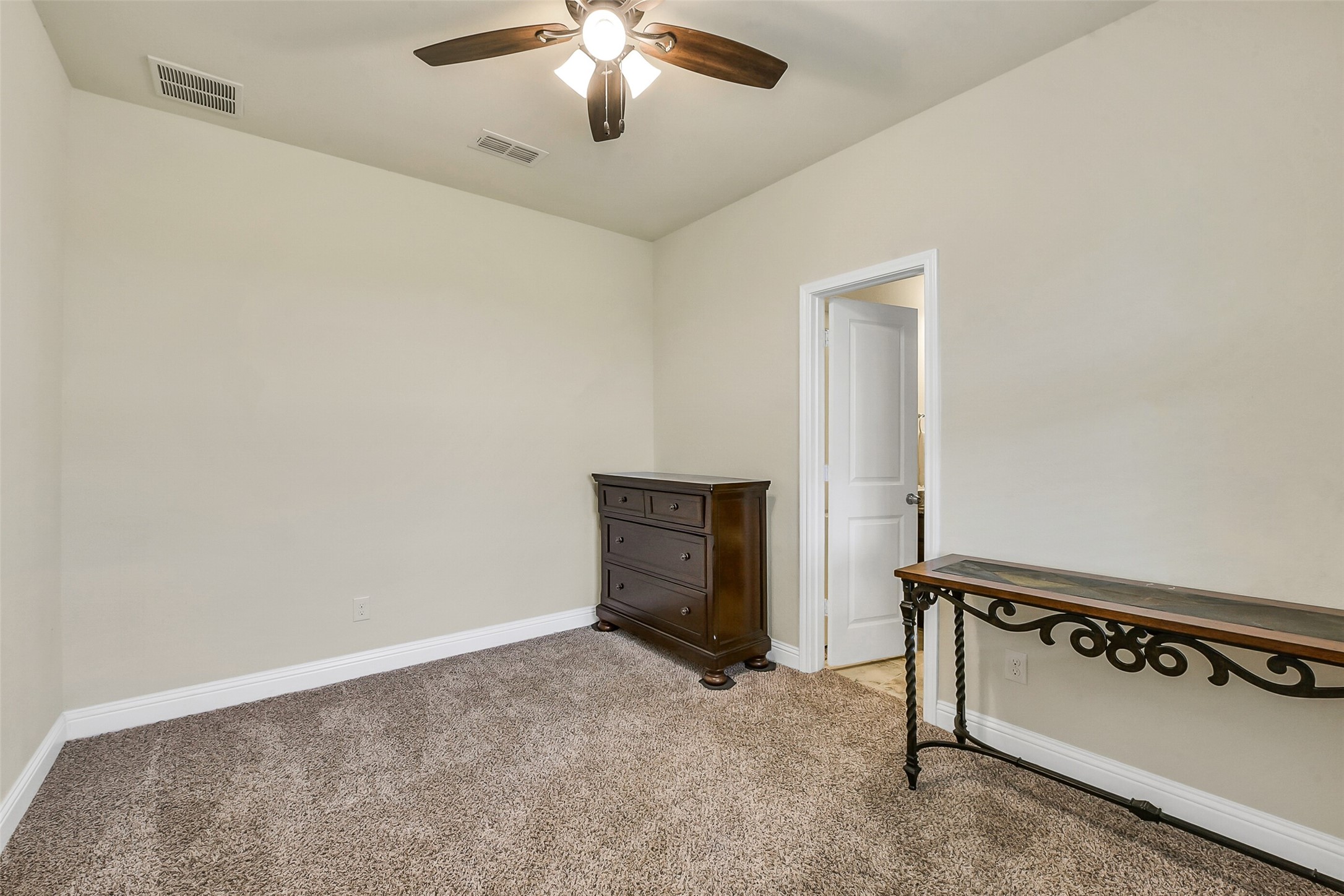9519 Carson Lane Rosharon, TX 77583 - Photo 30 of 39 an empty room with windows and fan