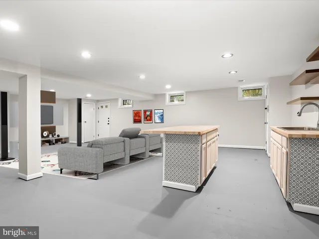 a living room with furniture and a washer dryer