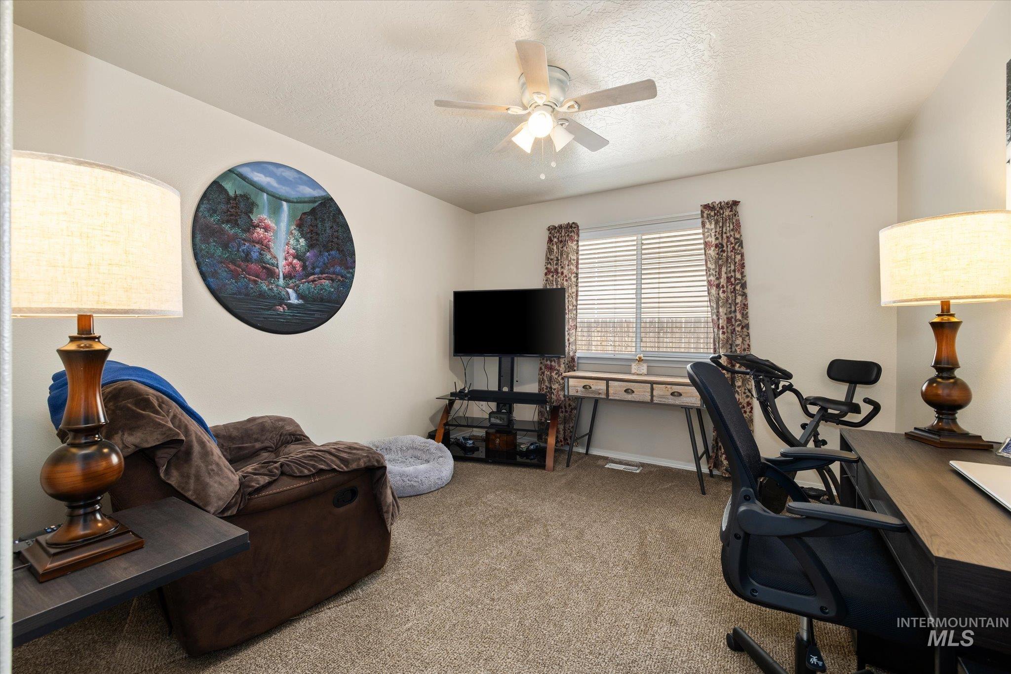 5401 Barkley Way Caldwell, ID 83607 - Photo 10 of 35 Carpeted interior space featuring a ceiling fan with integrated lighting, a window with horizontal blinds, and neutral wall tones
