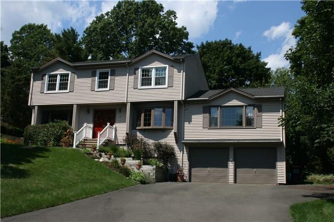 a front view of a house with a garden and yard