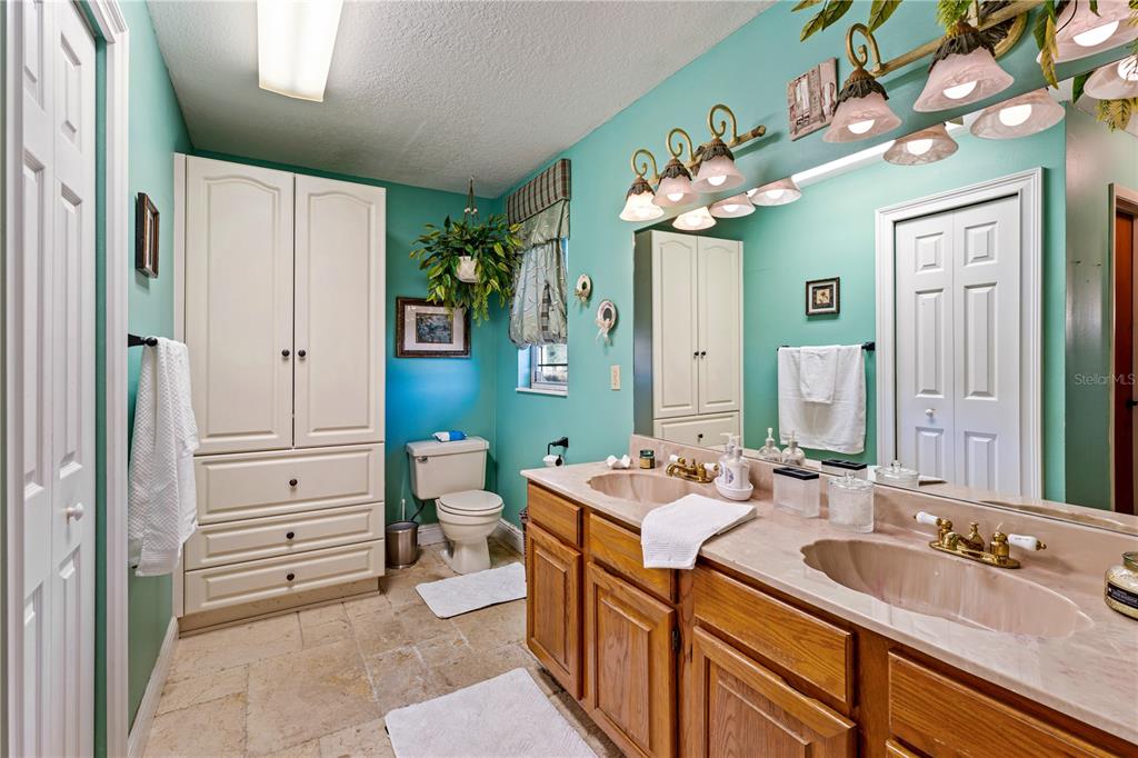 9504 Fort King Road Dade City, FL 33525 - Photo 17 of 51 a bathroom with a sink mirror and vanity