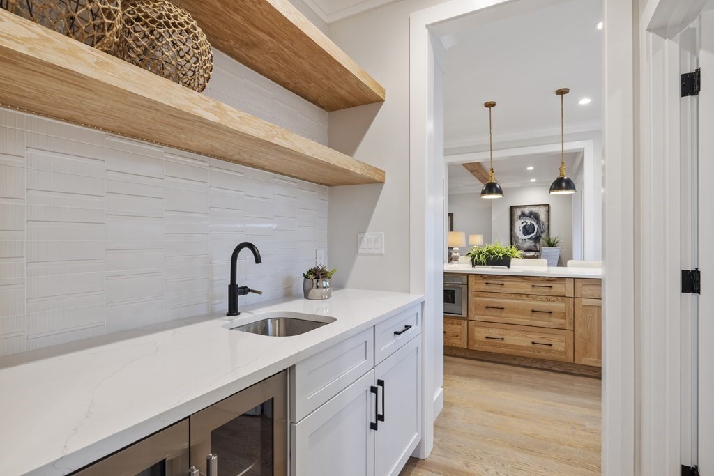 547 Webster Street Needham, MA 02494 - Photo 12 of 39 a kitchen with cabinets stainless steel appliances and wooden floor