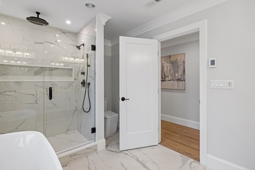 547 Webster Street Needham, MA 02494 - Photo 22 of 39 a bathroom with a shower and a glass door