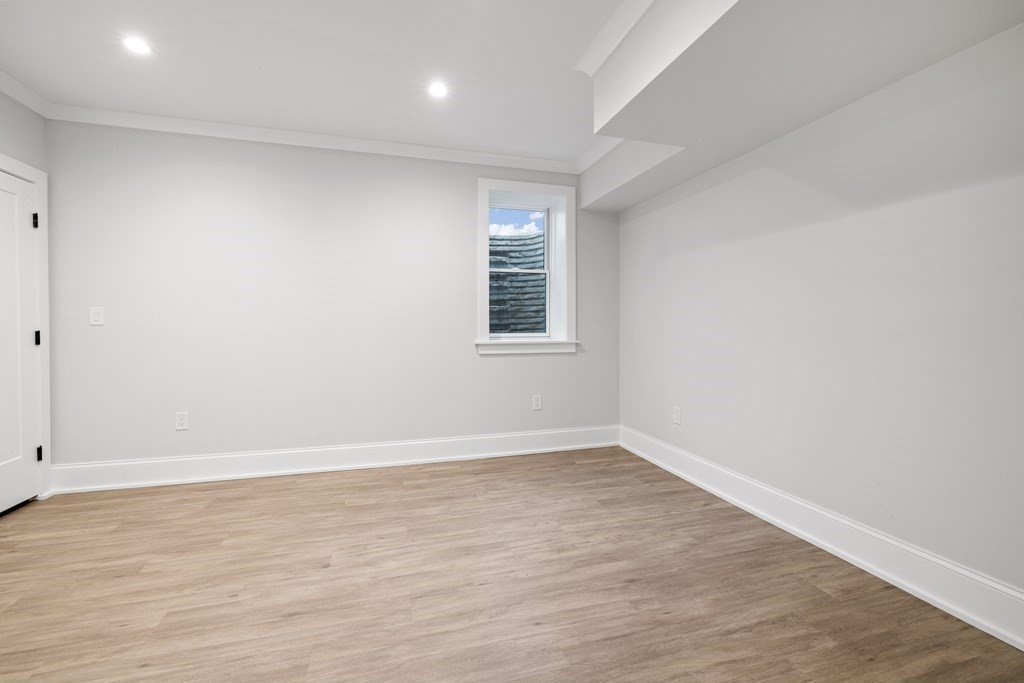 547 Webster Street Needham, MA 02494 - Photo 33 of 39 wooden floor in an empty room with a window