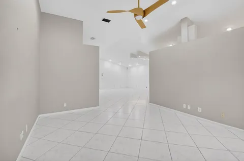 a large kitchen with stainless steel appliances granite countertop a refrigerator a stove a sink and a microwave