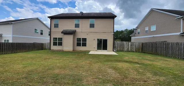 a view of a house with a yard and garage