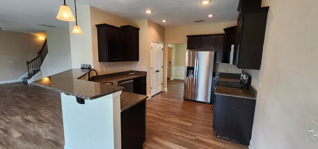 a kitchen with a refrigerator and a sink