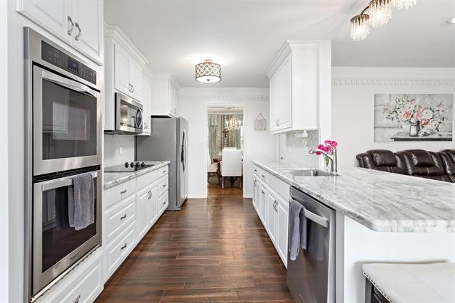 1535 Infinity Lane Beaumont, TX 77706 - Photo 11 of 35 a large kitchen with stainless steel appliances granite countertop a stove refrigerator and a sink