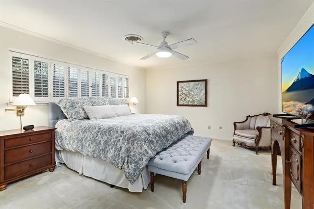 a spacious bedroom with a bed and a flat screen tv