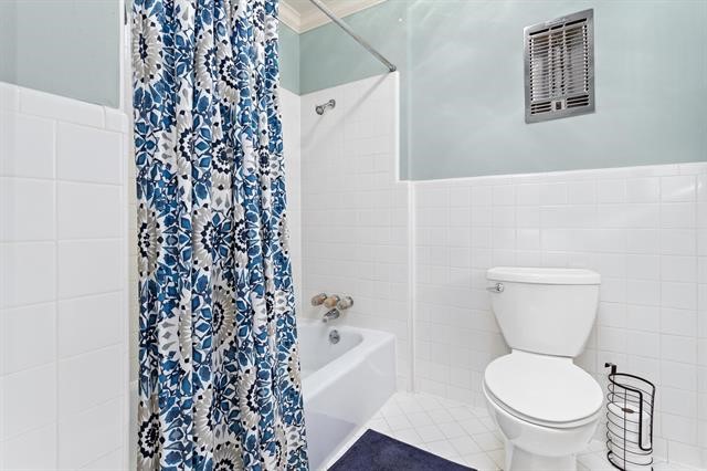1535 Infinity Lane Beaumont, TX 77706 - Photo 29 of 35 a white toilet sitting next to a shower curtain