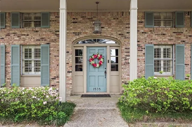 front view of a brick house with a outdoor shower