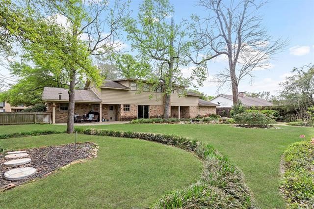 1535 Infinity Lane Beaumont, TX 77706 - Photo 35 of 35 a front view of a house with a garden and trees