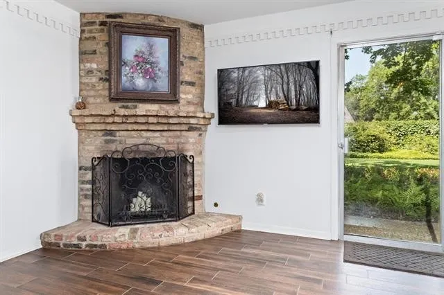 a living room with a fireplace and a painting on the wall