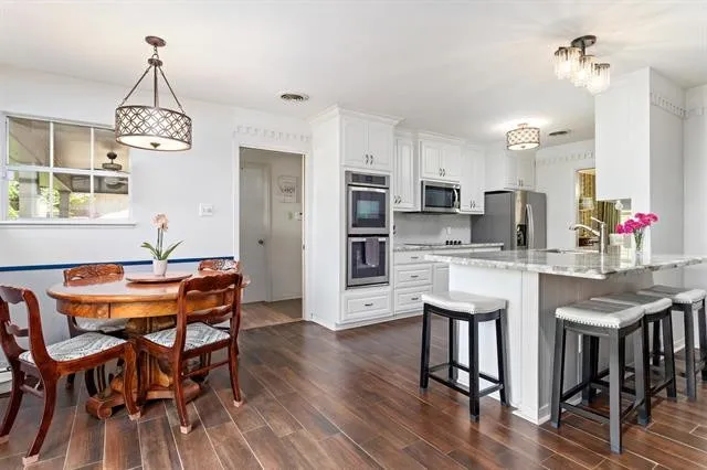 a view of a dining room with furniture and wooden floor