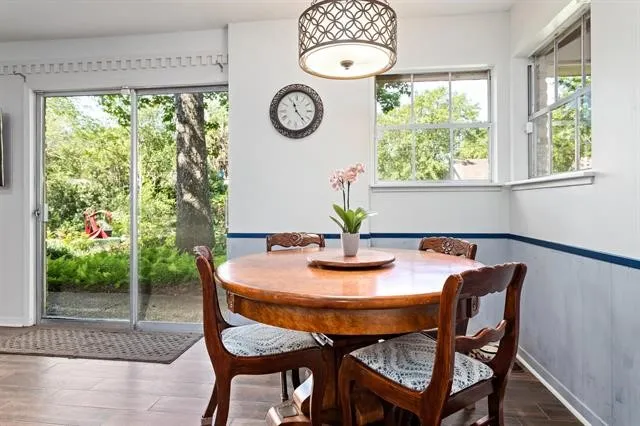 a dining room with furniture and window