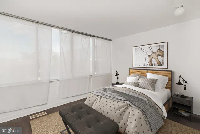 a bedroom with a bed and a window