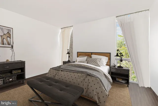 a bedroom with a bed and a window