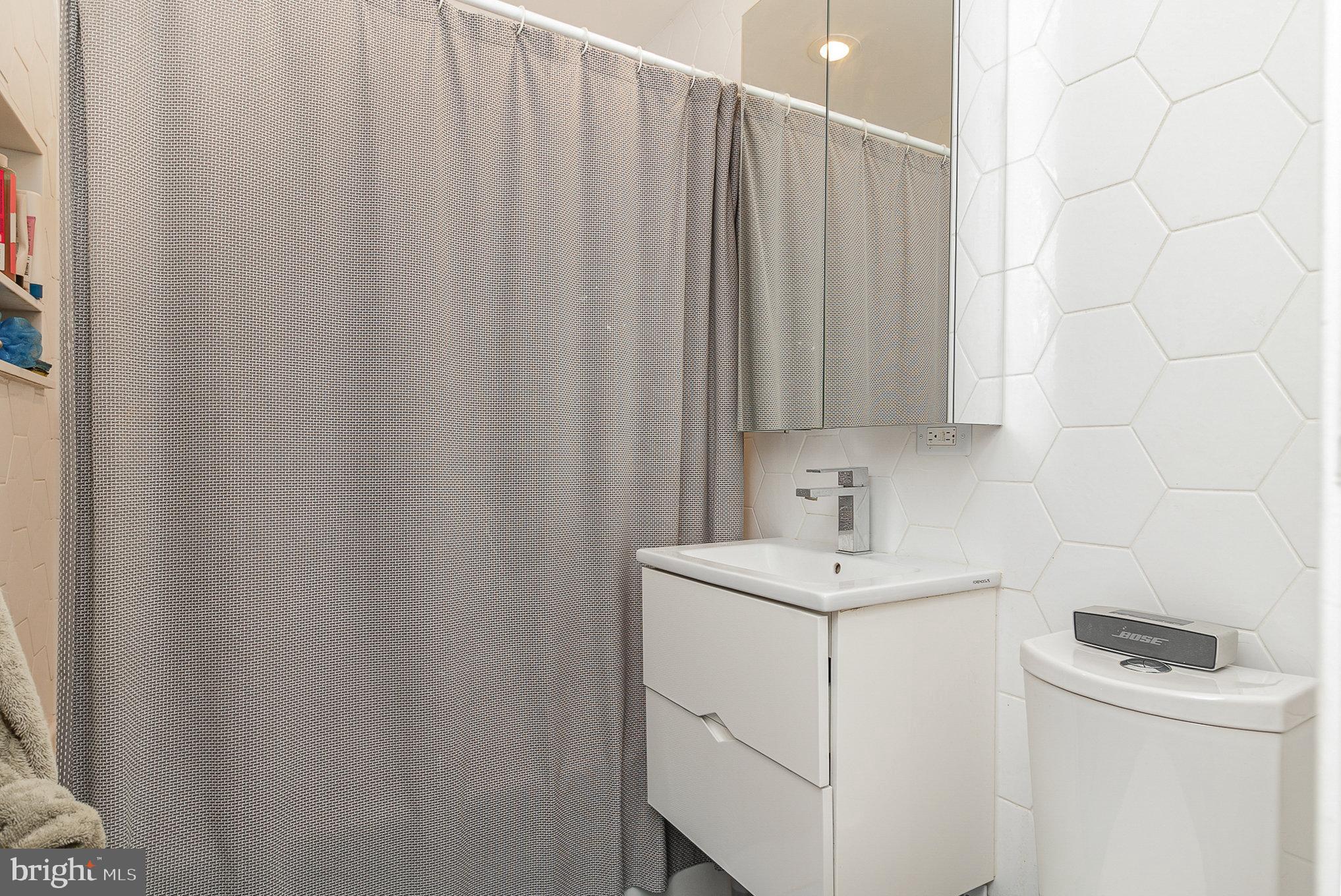 1338 4th Street Southwest, Unit T1338 Washington, DC 20024 - Photo 13 of 24 a bathroom with a sink a vanity and a mirror