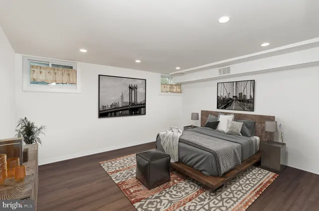 a bedroom with a bed and a painting on the wall