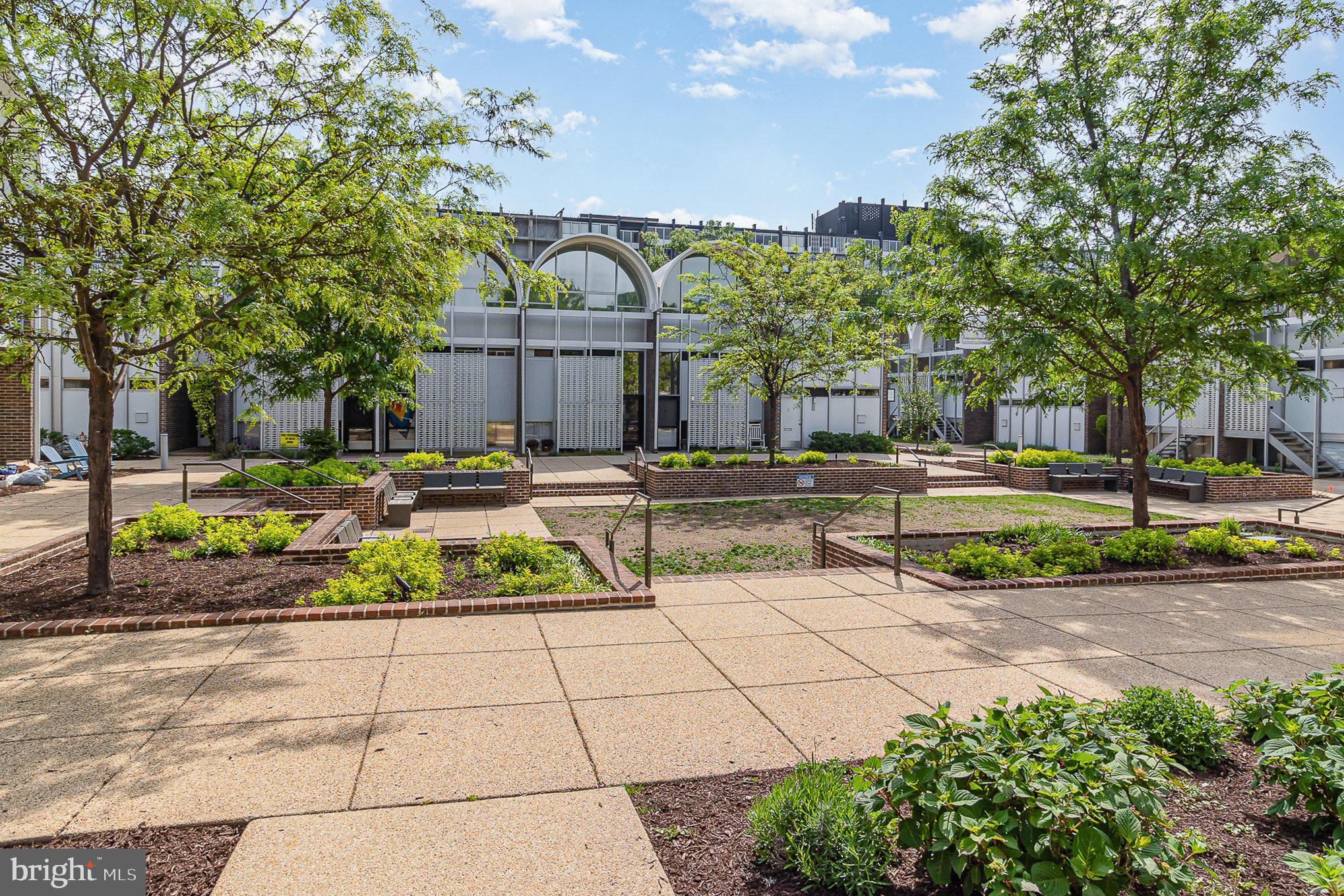 1338 4th Street Southwest, Unit T1338 Washington, DC 20024 - Photo 2 of 24 a view of a fountain with a bench in front of house