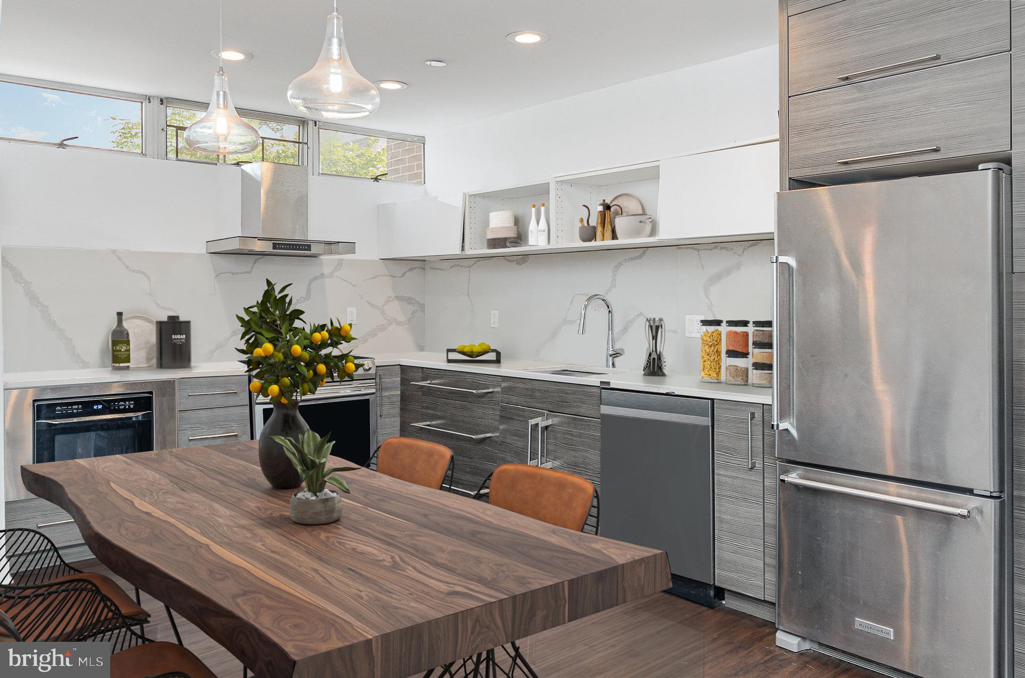 1338 4th Street Southwest, Unit T1338 Washington, DC 20024 - Photo 4 of 24 a kitchen with stainless steel appliances granite countertop a refrigerator a sink dishwasher a dining table and chairs with wooden floor