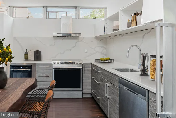 a kitchen with stainless steel appliances granite countertop a stove and a sink