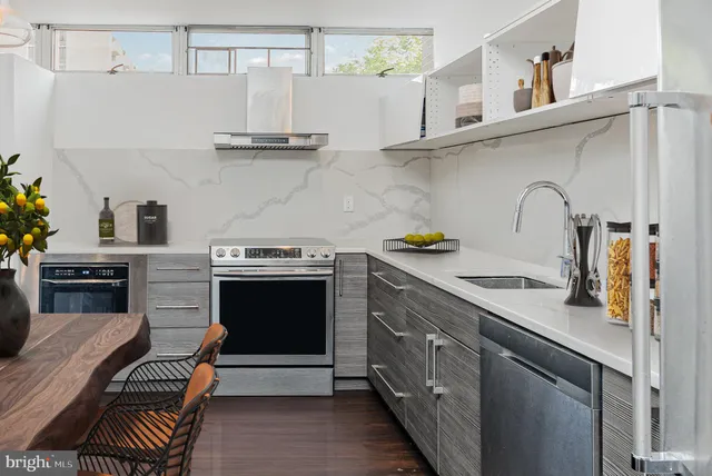 a kitchen with stainless steel appliances granite countertop a stove and a sink