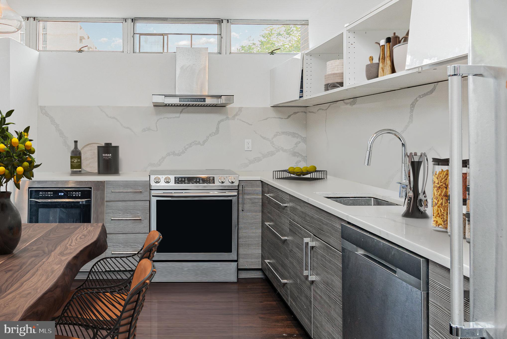 1338 4th Street Southwest, Unit T1338 Washington, DC 20024 - Photo 5 of 24 a kitchen with stainless steel appliances granite countertop a stove and a sink
