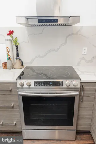 a stove top oven sitting inside of a kitchen