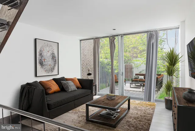 a living room with furniture and a floor to ceiling window
