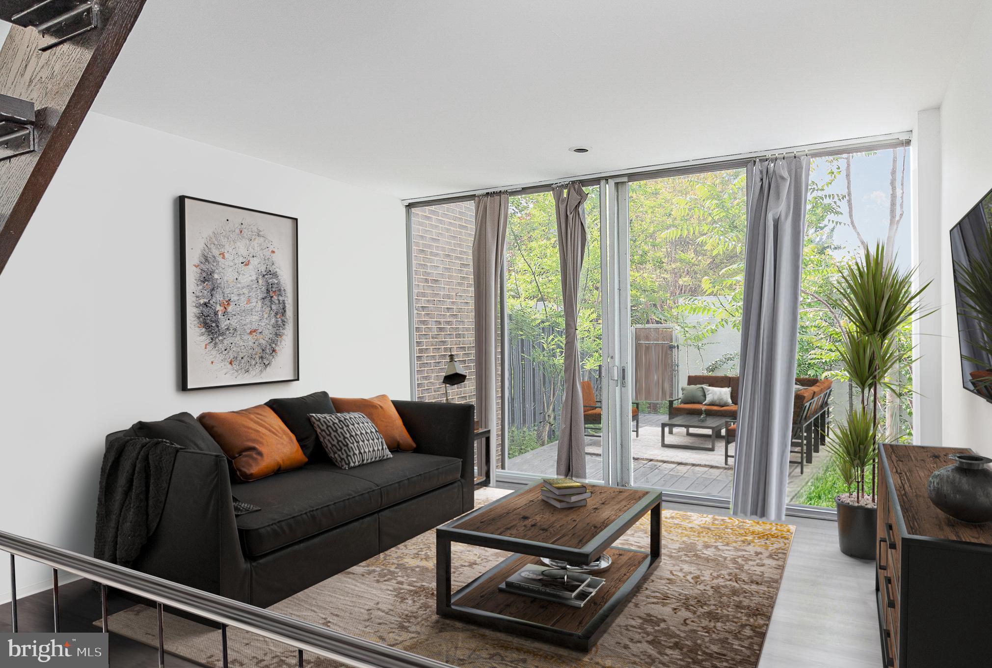 1338 4th Street Southwest, Unit T1338 Washington, DC 20024 - Photo 7 of 24 a living room with furniture and a floor to ceiling window