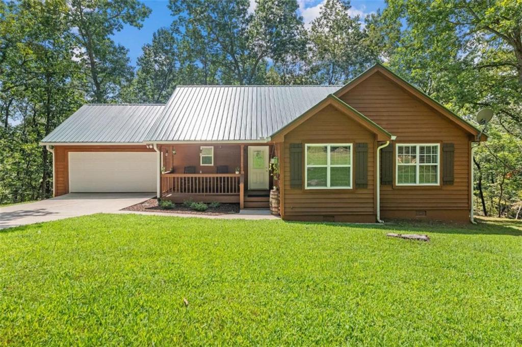 600 Ridge Lane Lula, GA 30554 - Photo 1 of 1 a front view of a house with a garden