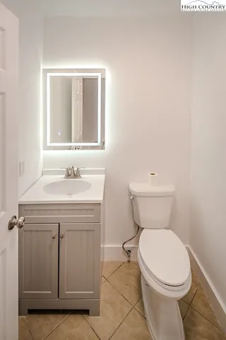 a bathroom with a sink toilet and mirror