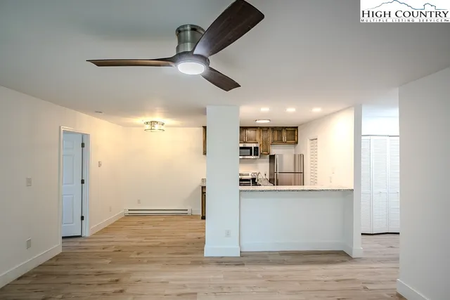 a view of a kitchen with a refrigerator and a window