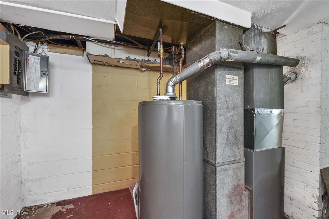 6506 Snow Road Parma, OH 44129 - Photo 25 of 25 Utility room featuring water heater, electric panel, and heating unit