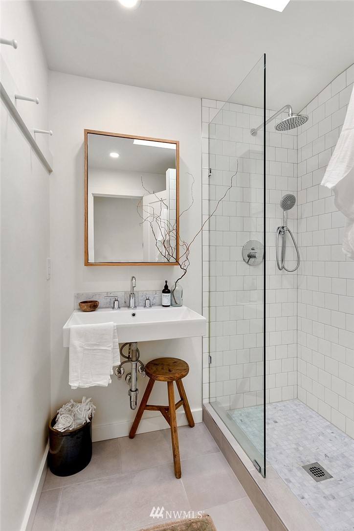 1102 North 30th Street Renton, WA 98056 - Photo 13 of 38 a bathroom with a sink mirror and a shower