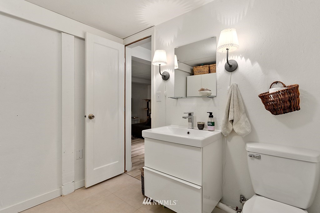 1102 North 30th Street Renton, WA 98056 - Photo 26 of 38 a bathroom with a sink toilet and mirror